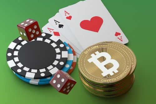 A 3D illustration featuring a stack of Bitcoin coins next to casino poker chips, red dice, and a set of playing cards including two aces, symbolizing the convergence of cryptocurrency and online gambling.