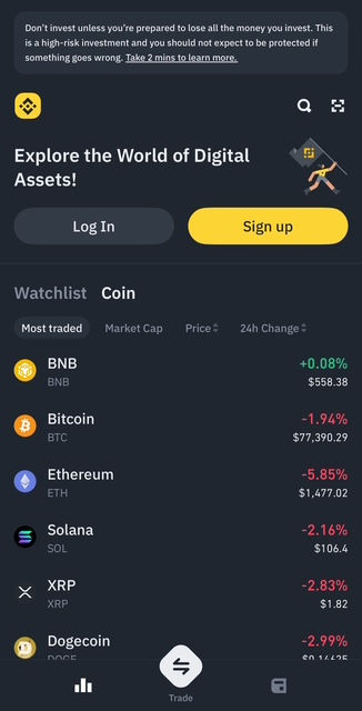 Screenshot of the Binance mobile app interface showing a warning about investment risks, with options to log in or sign up. Below is a live watchlist displaying the most traded cryptocurrencies including BNB, Bitcoin, Ethereum, Solana, and XRP with real-time prices and 24-hour percentage changes.


